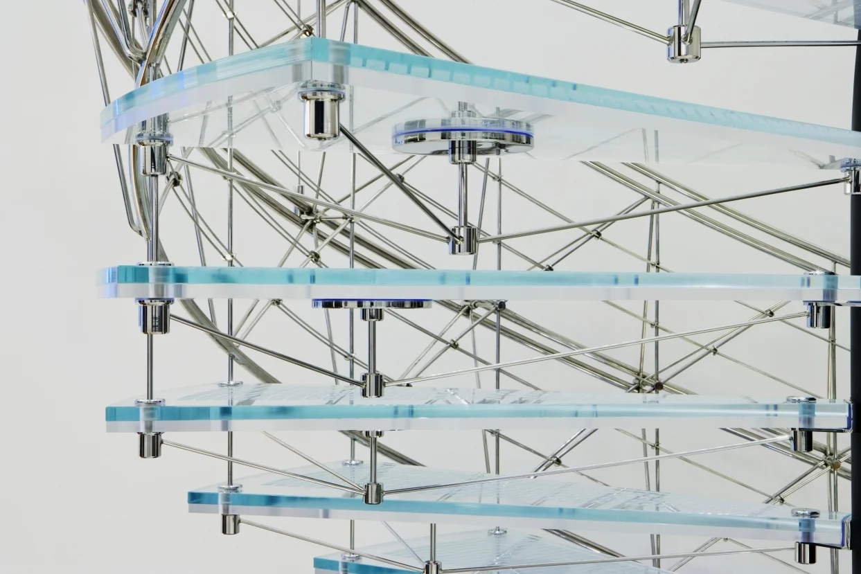 Close view of the laminated glass treads carried on a dense lattice of thin stainless steel rods and discs